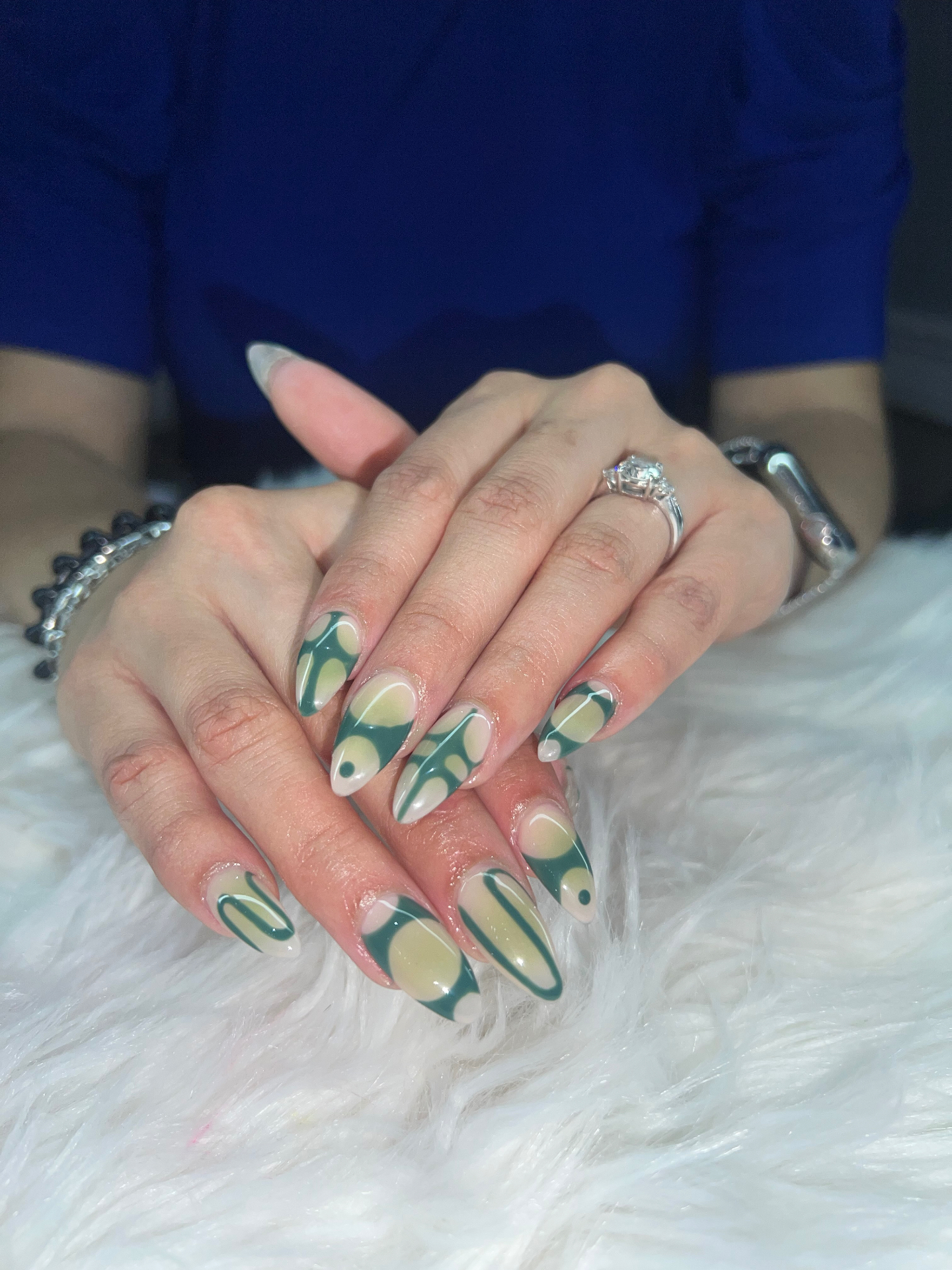 Abstract green and cream swirl nail design