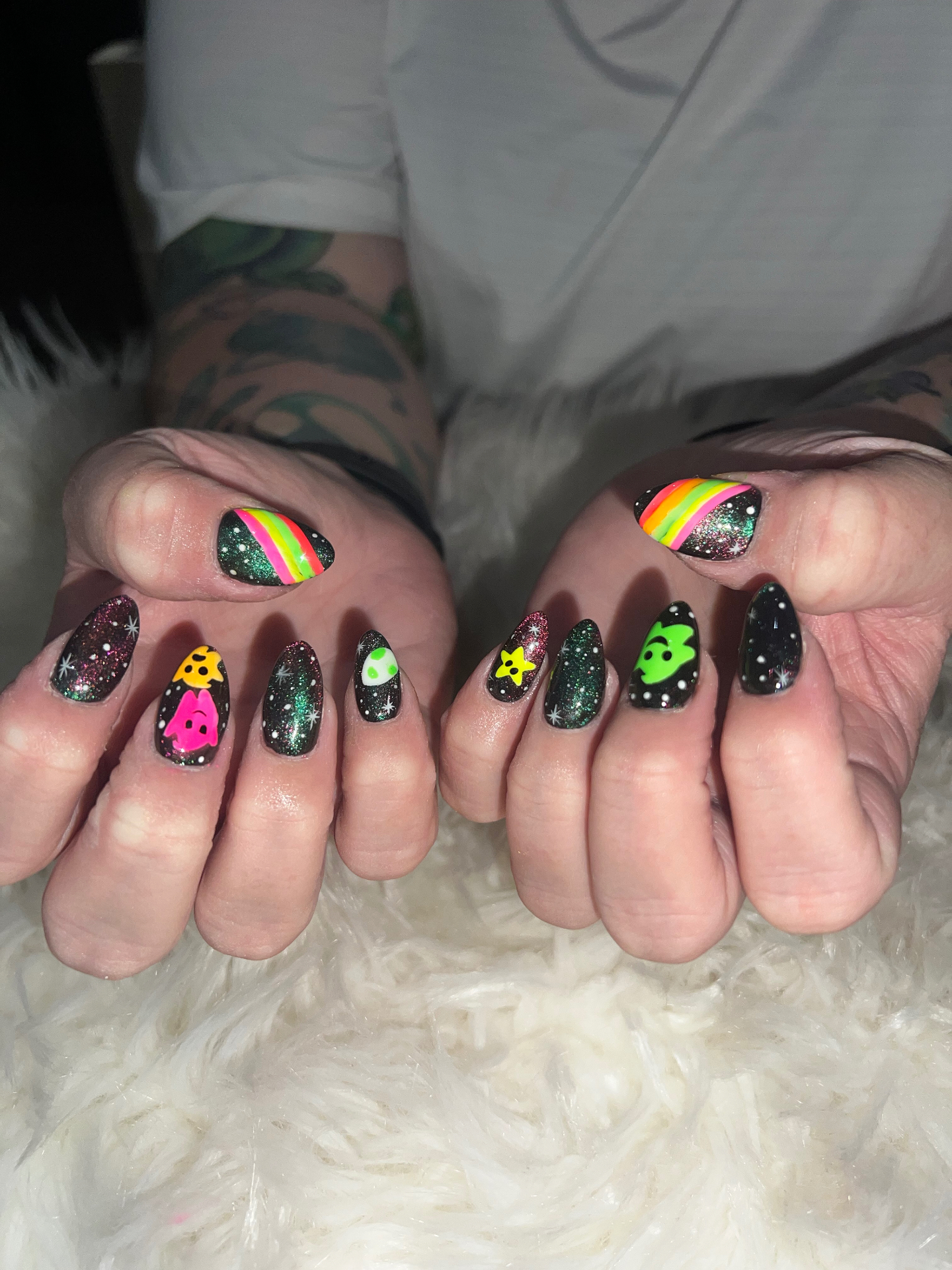 Neon glow ghost and star nail art on black glitter